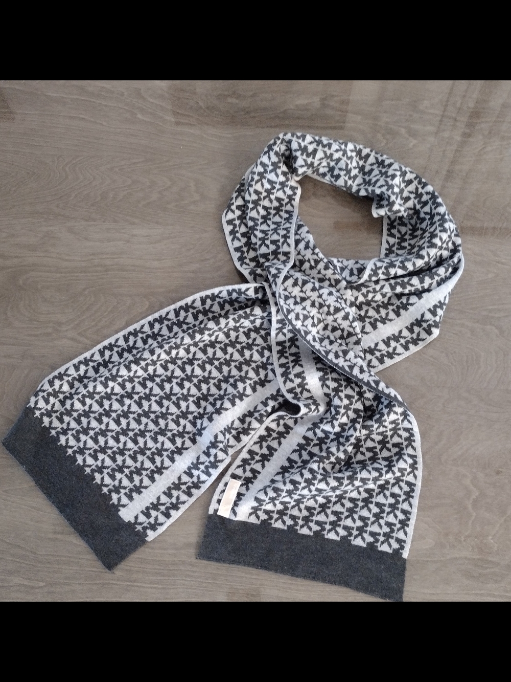 Michael Kors knit scarf features a prominent charcoal gray and white logo  Scarf